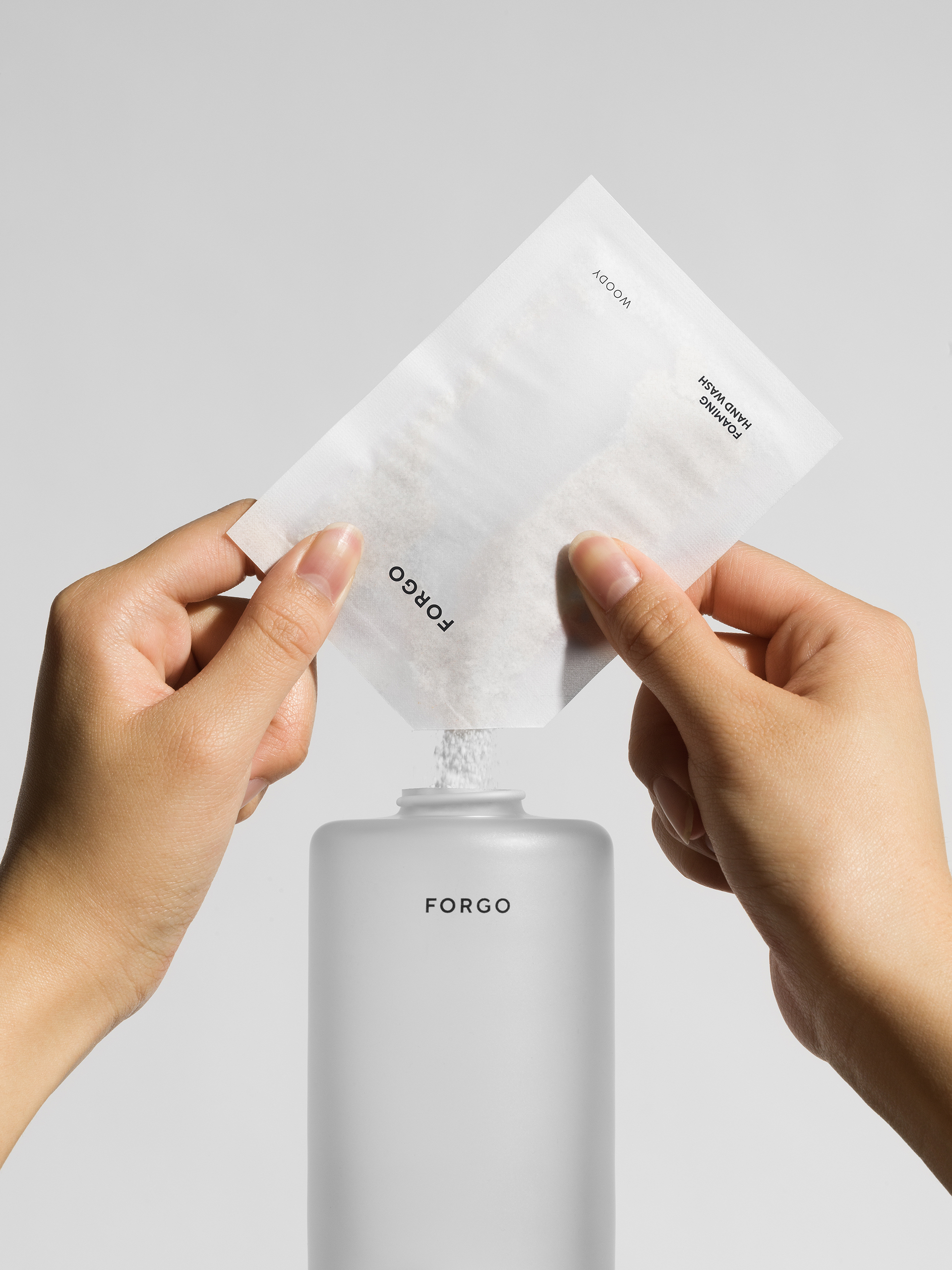 Pouring soap powder into bottle